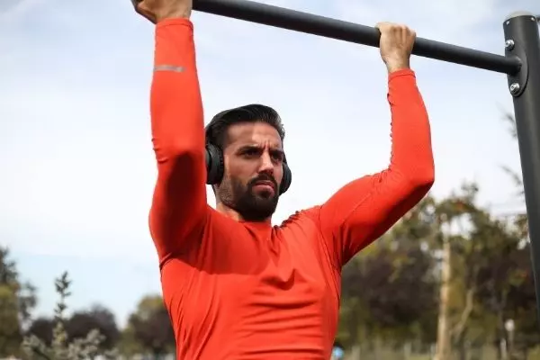 An Image Of A Man Doing Push Ups With Headphones On.