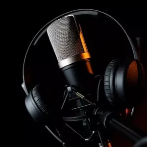 A Picture Of A Headset Hanging Around A Microphone